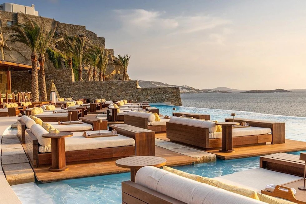 Mykonos beach club with sunbeds and turquoise water